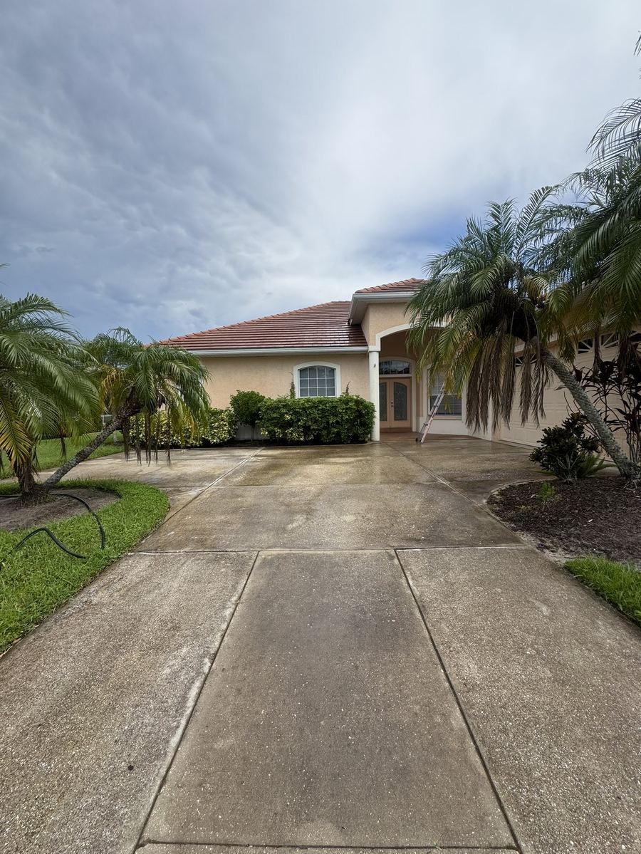 Home exterior and driveway before pressure washing